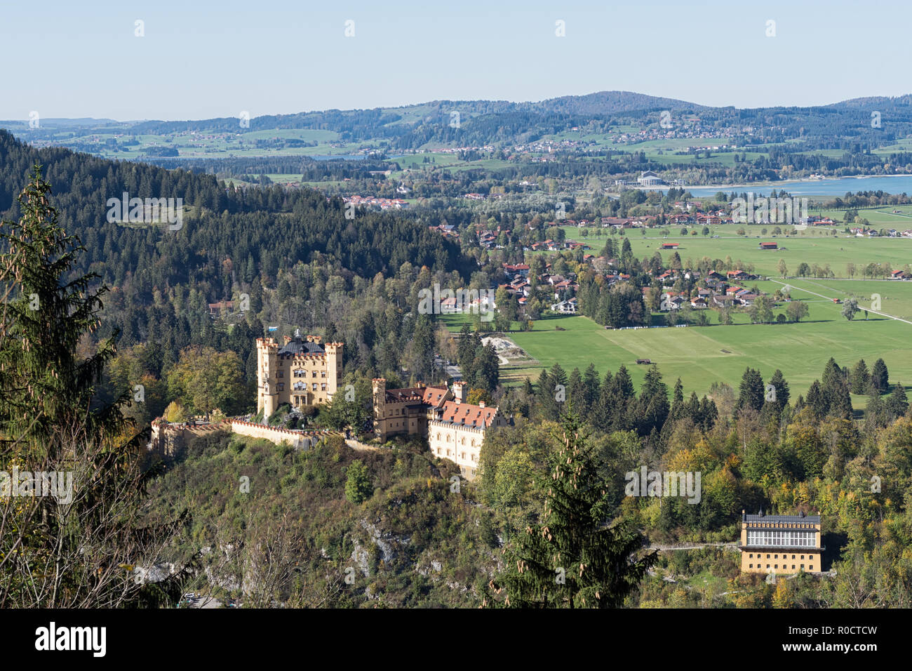 View from a path around the Lake Alpsee to Hohenschwangau Castle,  Alterschrofen, Fuessen and lake Forggensee in autumn. Schwangau, Germany, 2018 Stock Photo