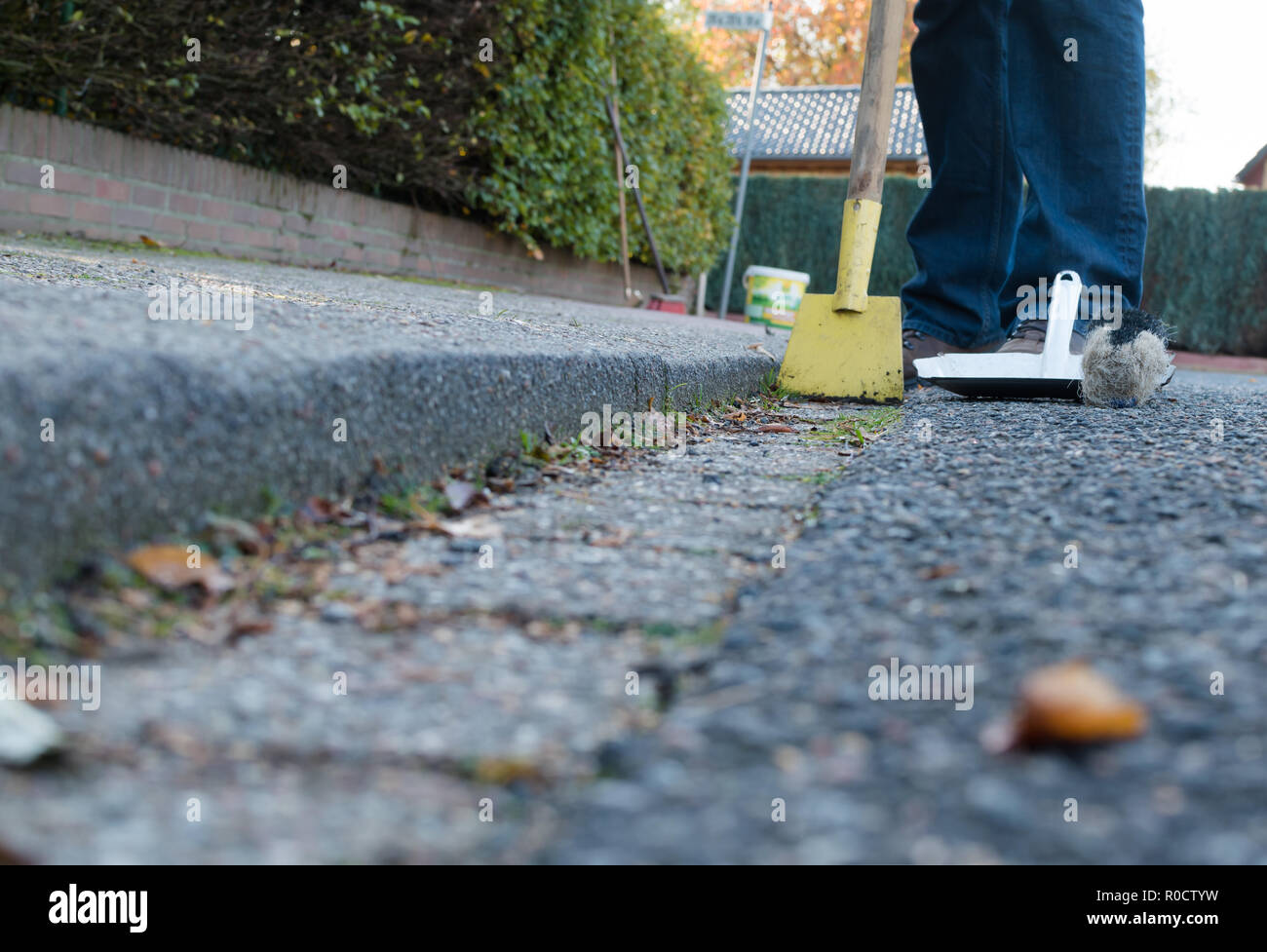 Man is cleaning the street gutter Stock Photo