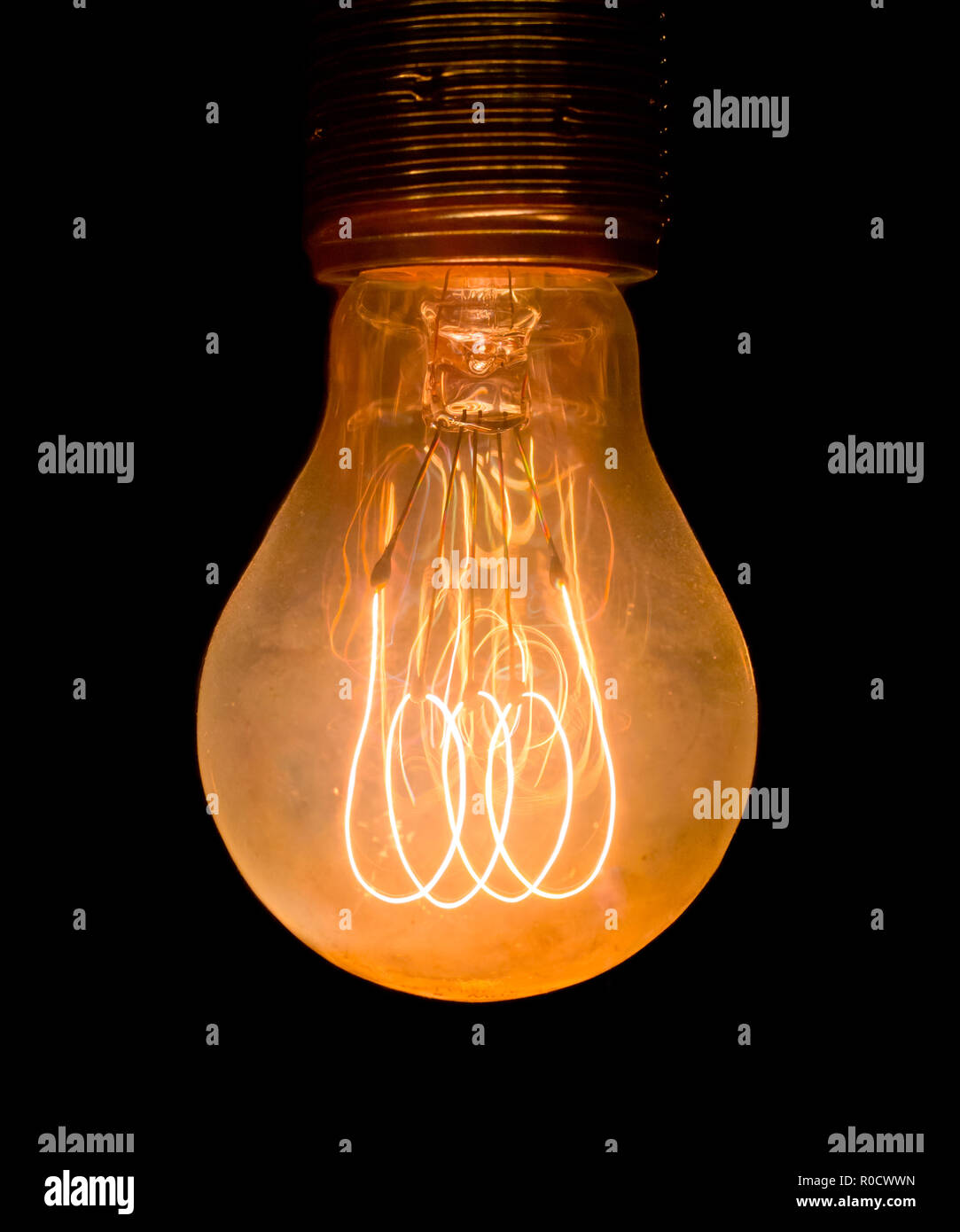 Vintage electric light bulb glowing in the dark Stock Photo Alamy