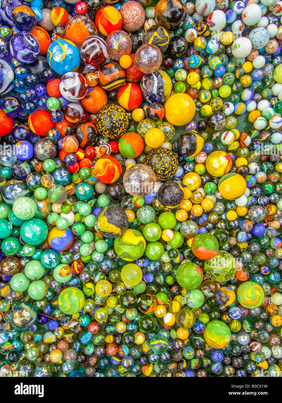 Background of glass marbles of different sizes in a color pattern Stock