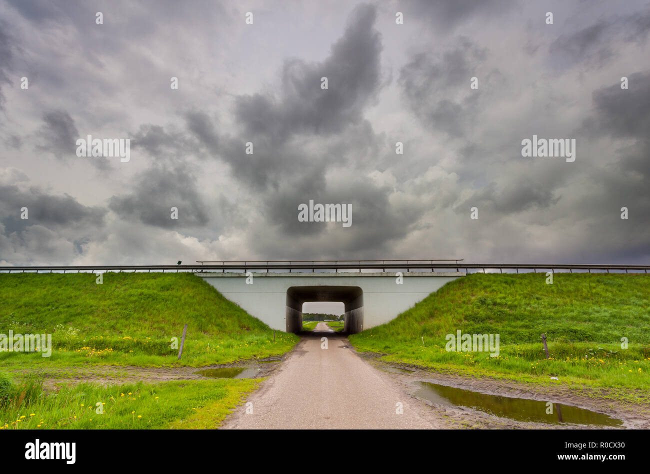 Tunnel leading to clouds as a metaphor for approaching a problematic period in life Stock Photo