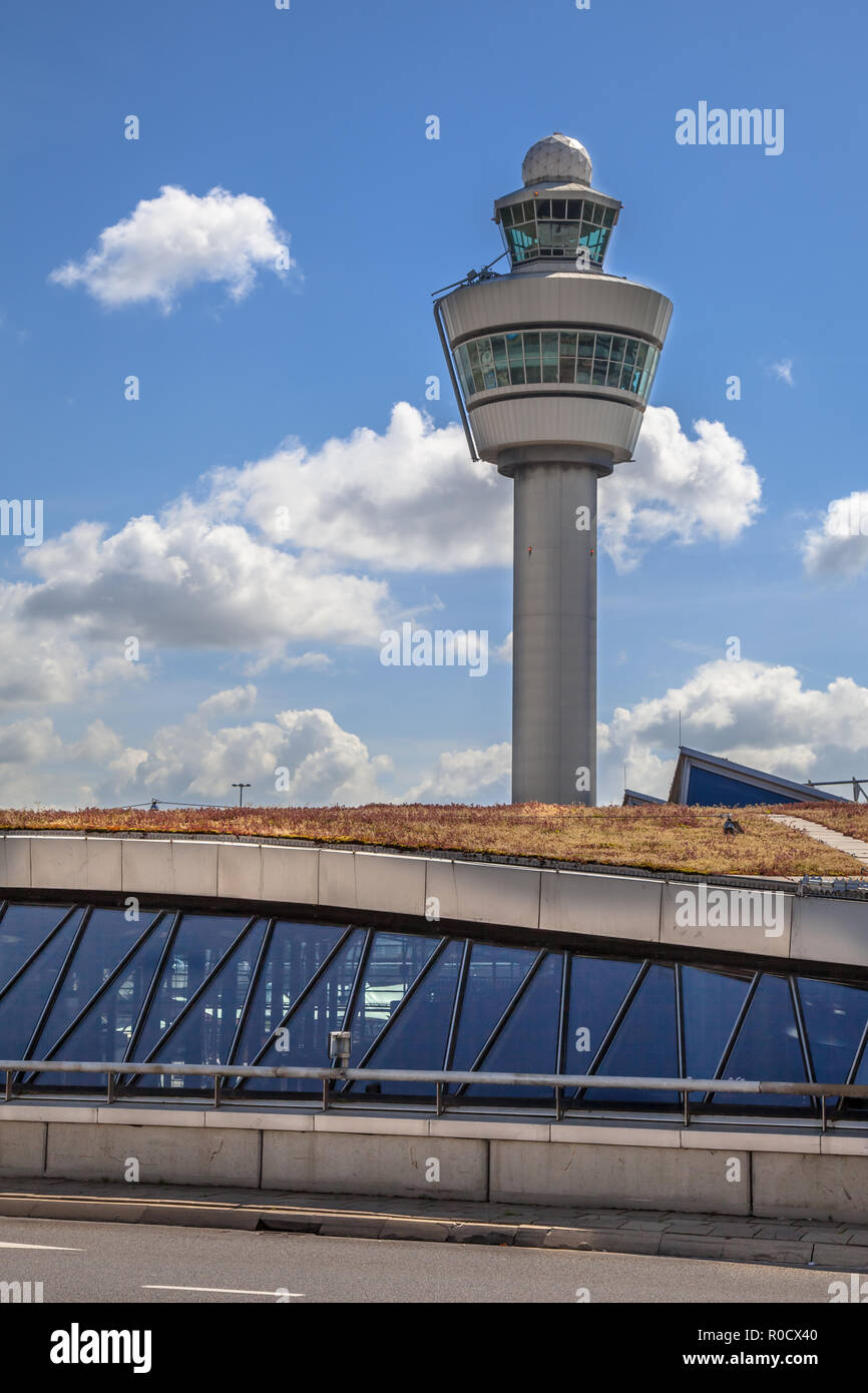 Air traffic control tower on a big international airport with long term underground parking facility on the foreground Stock Photo