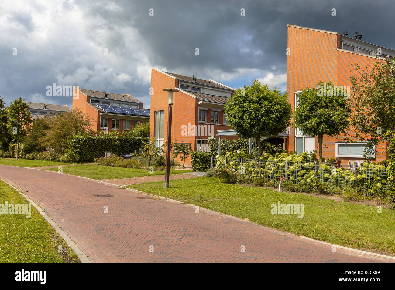 Street with large detached houses in a suburb of Wageningen City, Netherlands Stock Photo