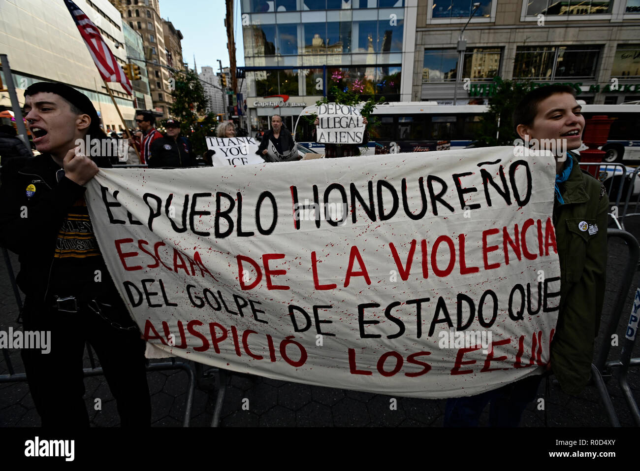 New York, U.S. 03 November 2018. Demonstrators hold a sign in Spanish reading "The Honduran people are escaping the violence of the coup d'etat that the U.S. sponsored" while counter-demonstrators behind them hold signs calling for deportation of undocumented immigrants. Anti-Trump protesters were rallying in Union Square against Trump administration immigration policies. The anti-Trump event, three days before the U.S. mid-term elections, was sponsored by several groups including NYC Democratic Socialists of America and the International Socialist Organization. Credit: Joseph Reid/Alamy L Stock Photo