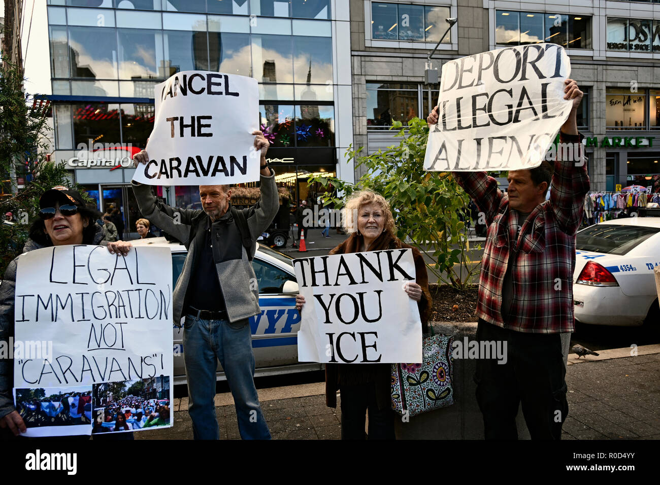 New York, U.S. 03 November 2018.  A small group of pro-Trump counter-demonstrators hold signs denouncing undocumented immigration as demonstrators protesting against Trump administration immigration policies rallied at Union Square.  The anti-Trump event, three days before the U.S. mid-term elections, was sponsored by several groups including NYC Democratic Socialists of America and the International Socialist Organization. Credit: Joseph Reid/Alamy Live News Stock Photo