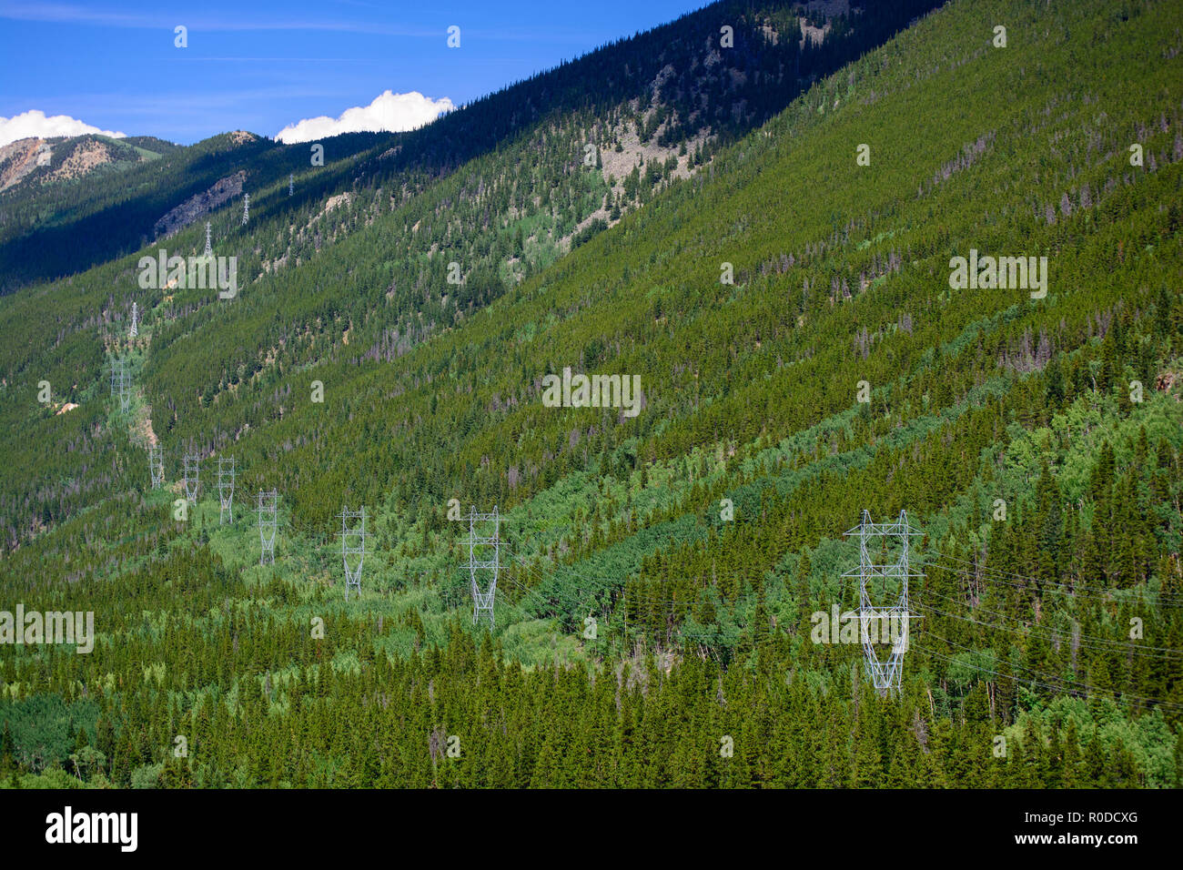High Tension High Voltage Power Lines in the Mountains Stock Photo