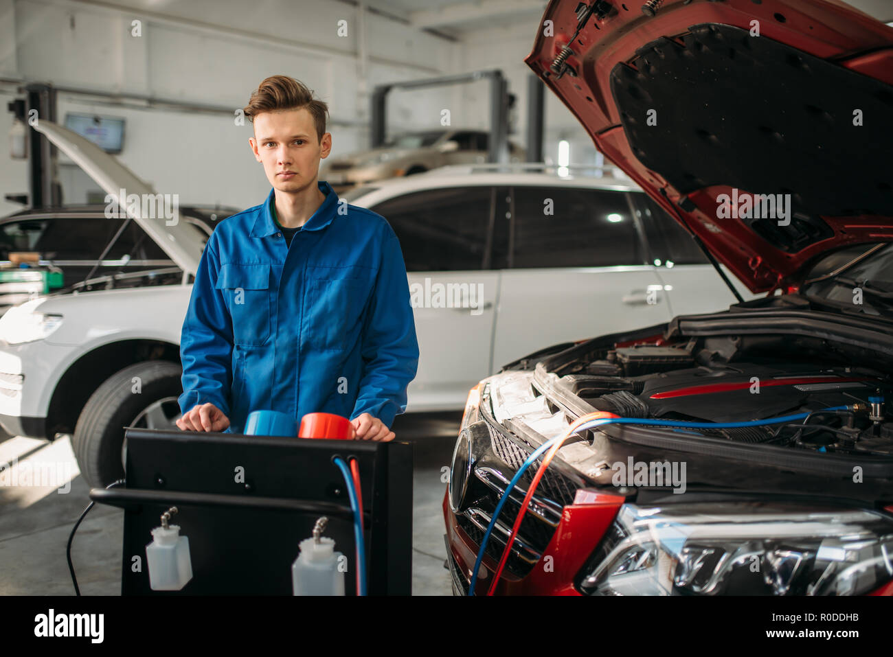 Mechanic stands at the air conditioning diagnostic system. Conditioner inspection in car service