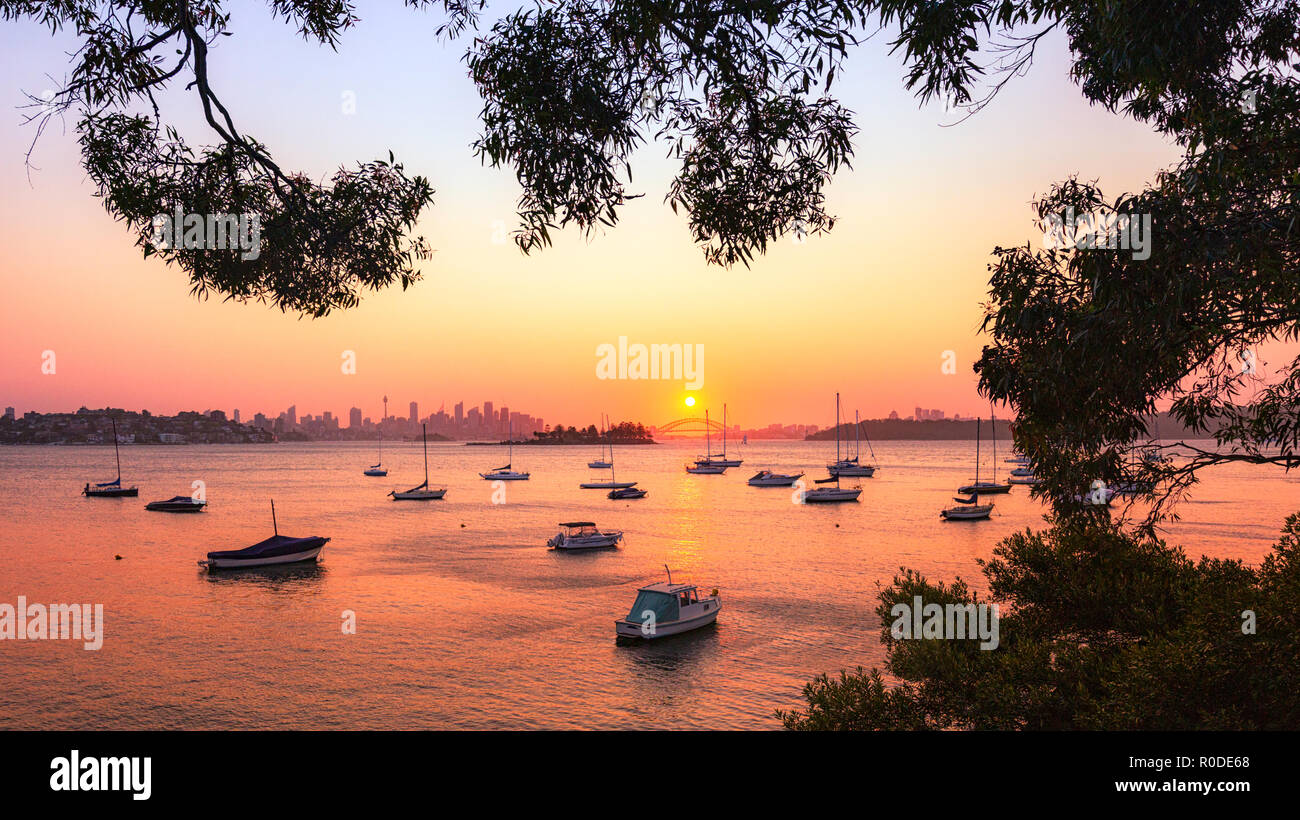 A beautiful sunset over Sydney  Harbour Bridge reflected in the tranquil waters of Hermit Bay in Vaucluse.Viewed from the Hermitage Foreshore Walk Stock Photo
