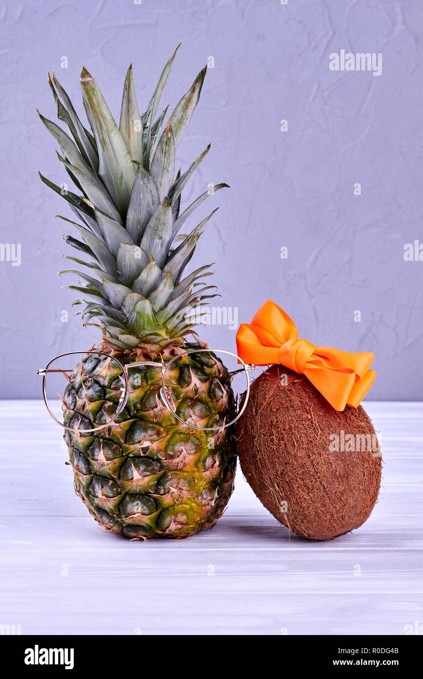 Stylish pineapple and coconut on grey background. Stock Photo