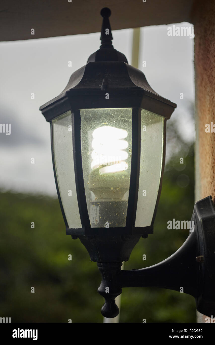 Outdoor lamp with light bulb dirty and damaged by the weather Stock Photo -  Alamy