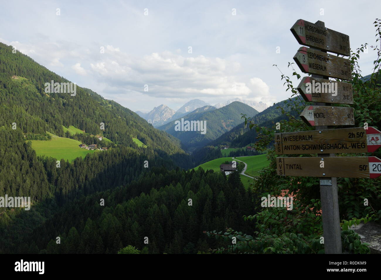 Signposts in front of an alpine mountain landscape Stock Photo