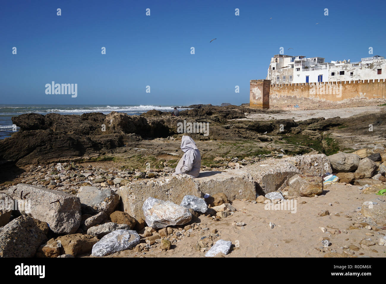 Local on the beach of Skala de la Ville in front of medina, Essaouira, Morocco Stock Photo