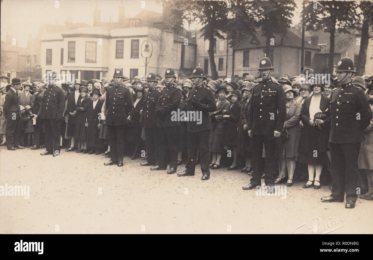 Vintage Photographic Postcard of Policemen Holding Back a Crowd of People at Some Public Event. Stock Photo