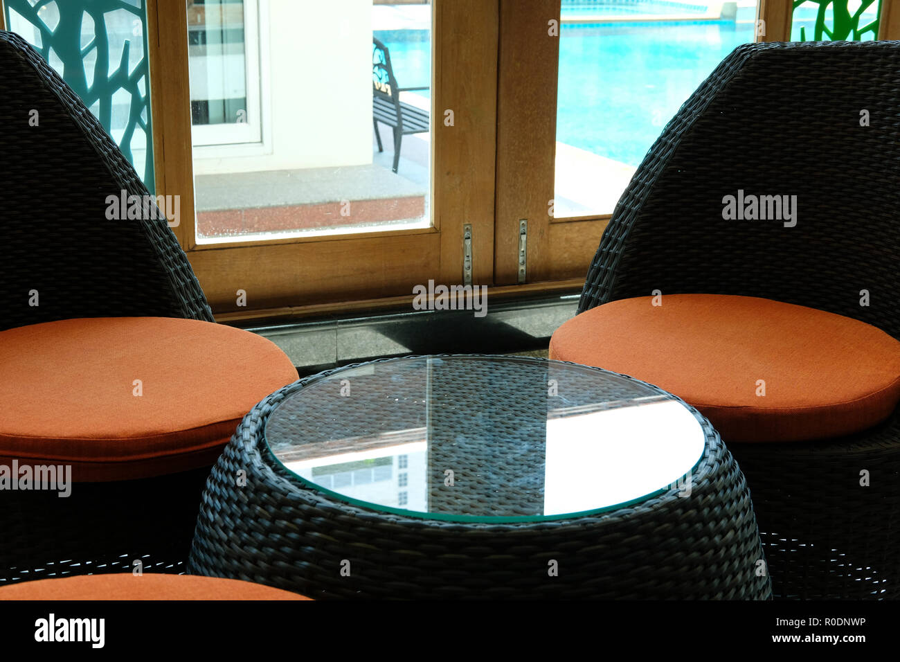 Cozy Rattan Chair With Orange Cushion In Living Room In