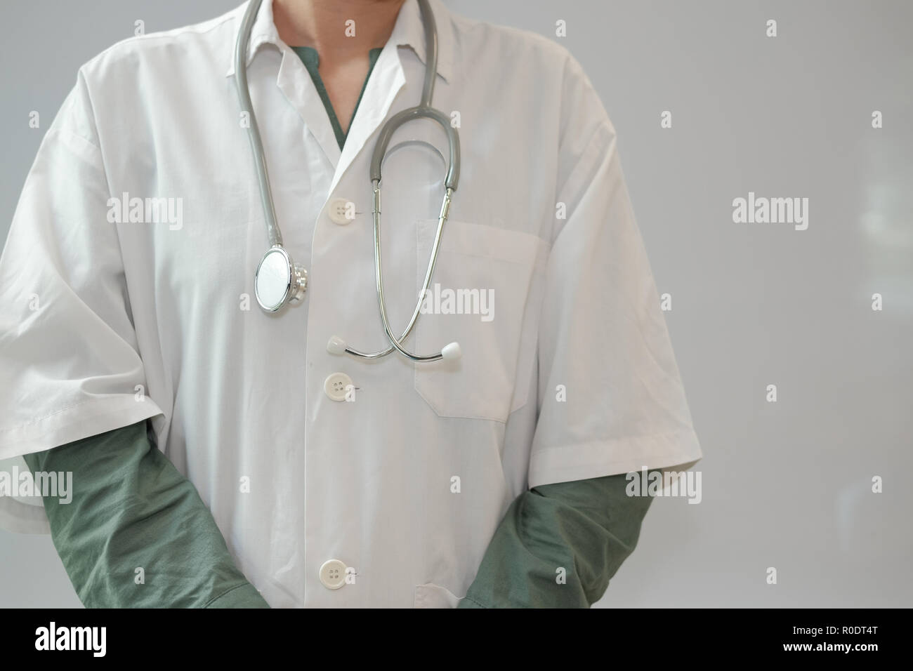 physician doctor medical practitioner with stethoscope to auscultate