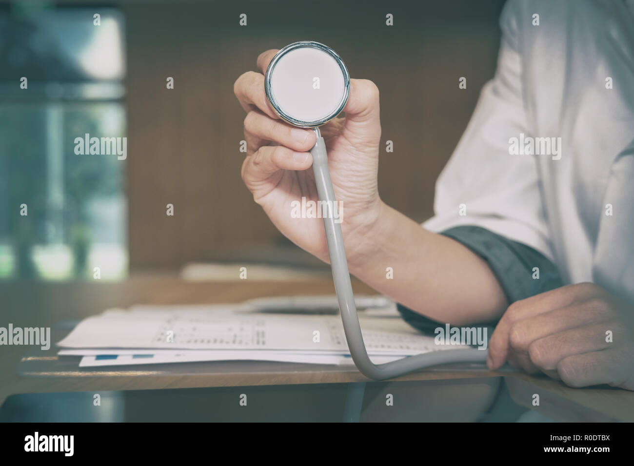 physician doctor medical practitioner with stethoscope to auscultate