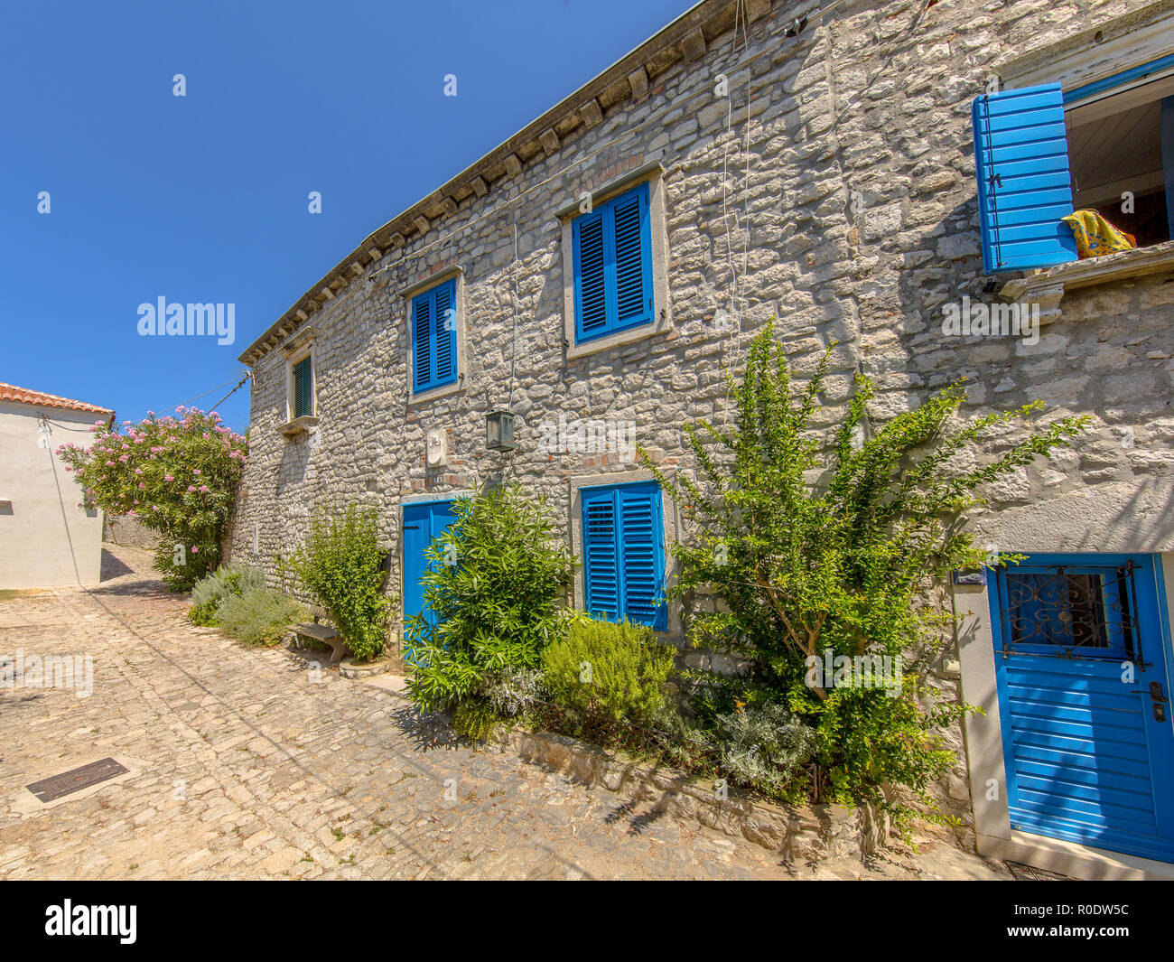 Traditional Croatian houses with blue painted windows in town of Osor on Cres Island, Istria, Croatia, Europe Stock Photo