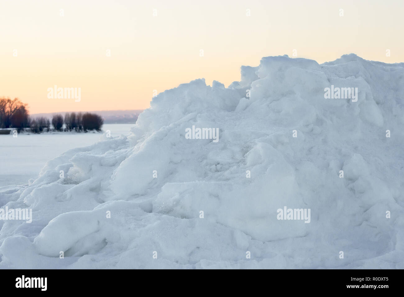 High snow hummock against the evening sky after sunset in winter Stock Photo