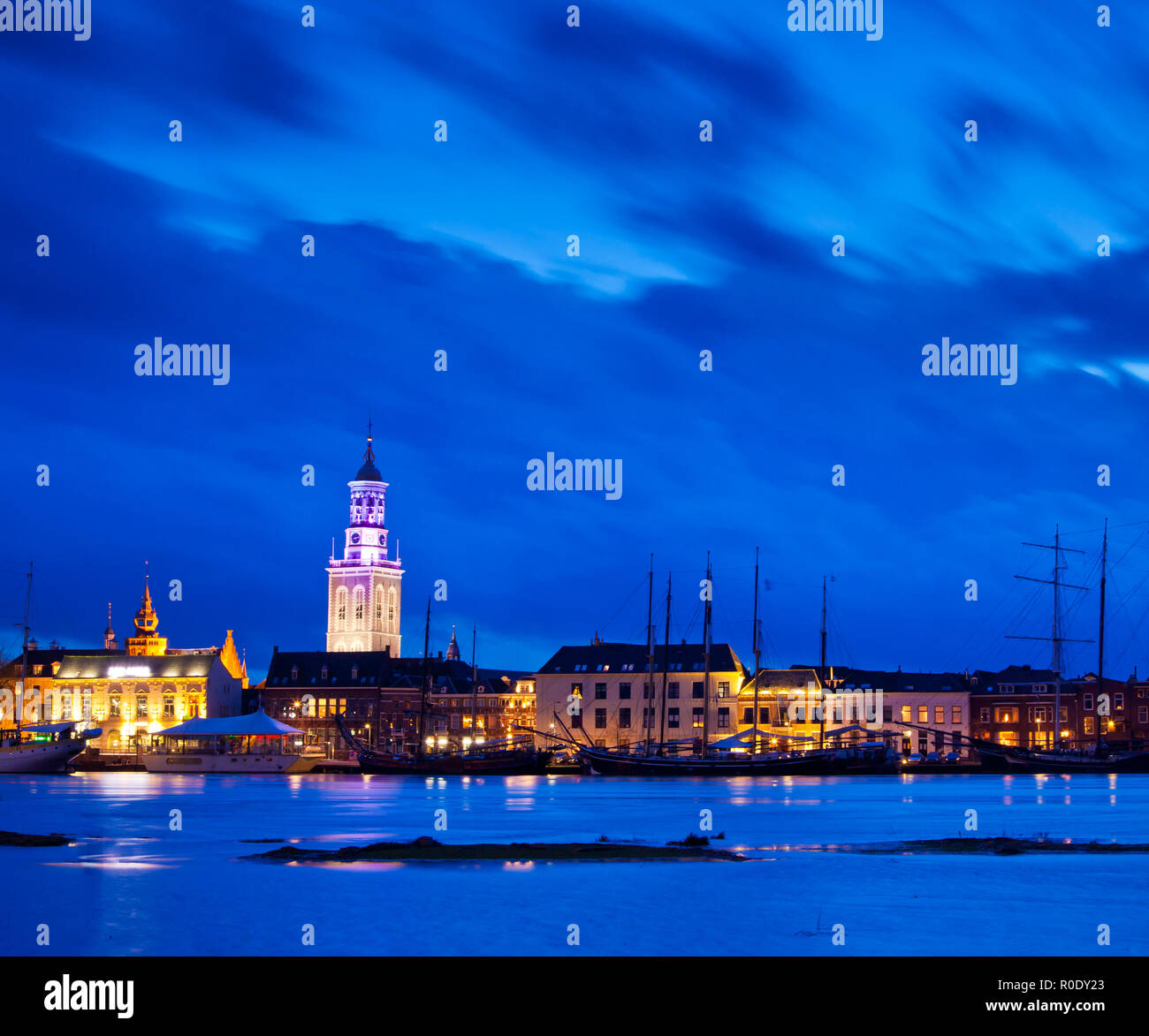 Old Wooden Sailing Ships on the Riverside in the Historical City of Kampen, Overijssel, Netherlands by Night Stock Photo