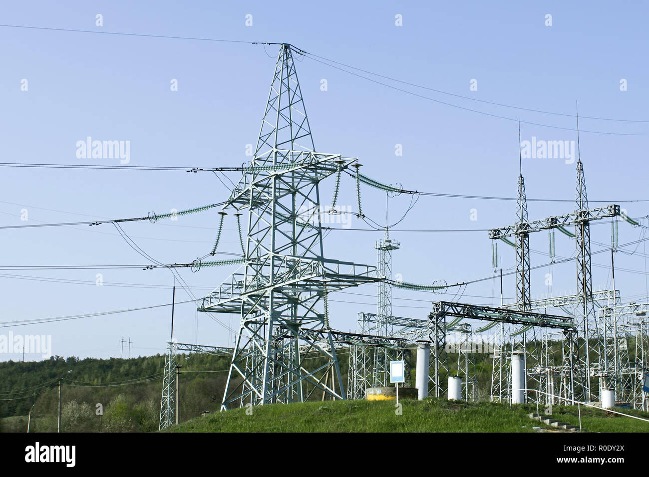 Towers of high voltage transmission lines and other electrical engineering equipment Stock Photo