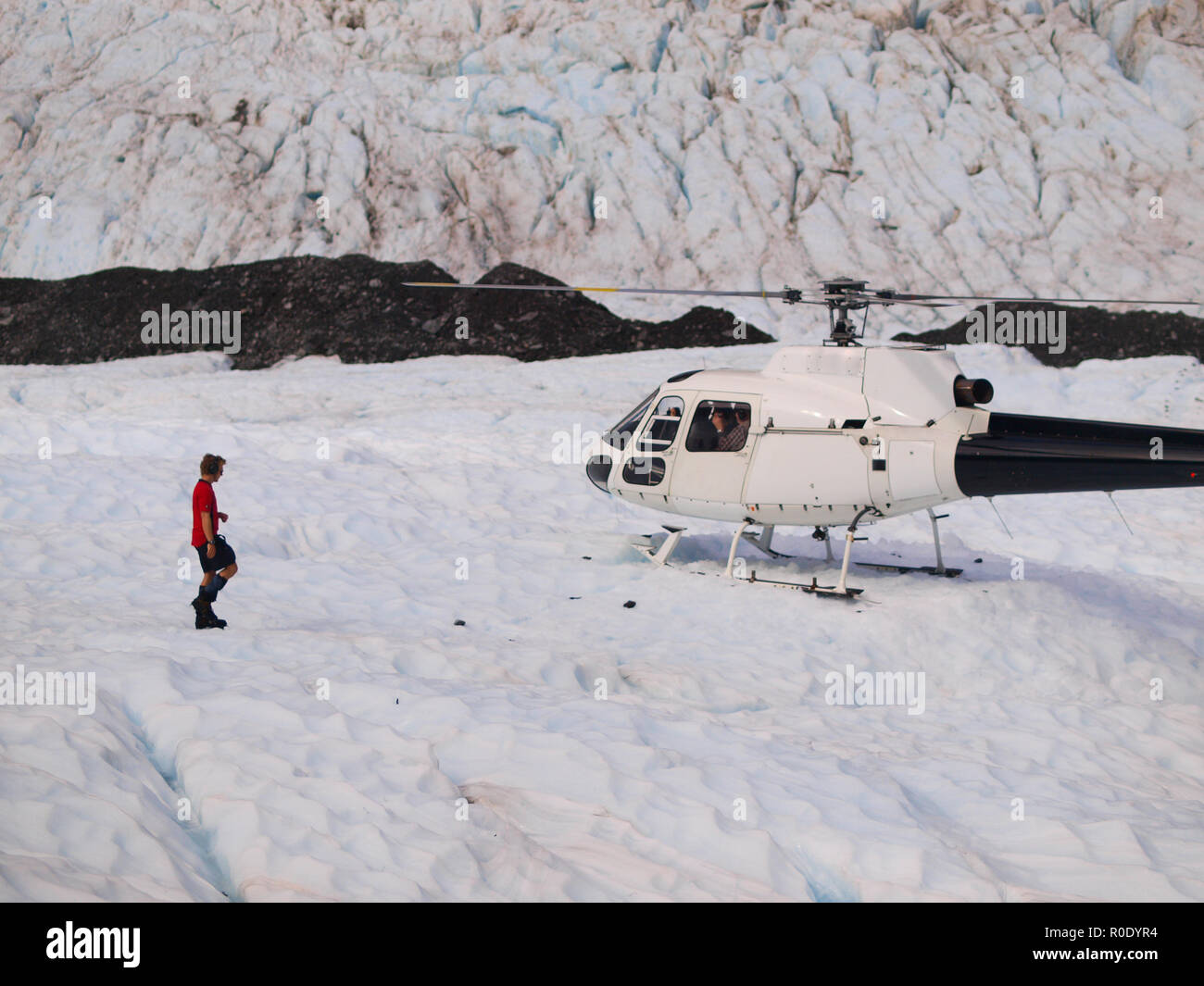 Helicopter landing on Franz josef glacier in New Zealand Stock Photo