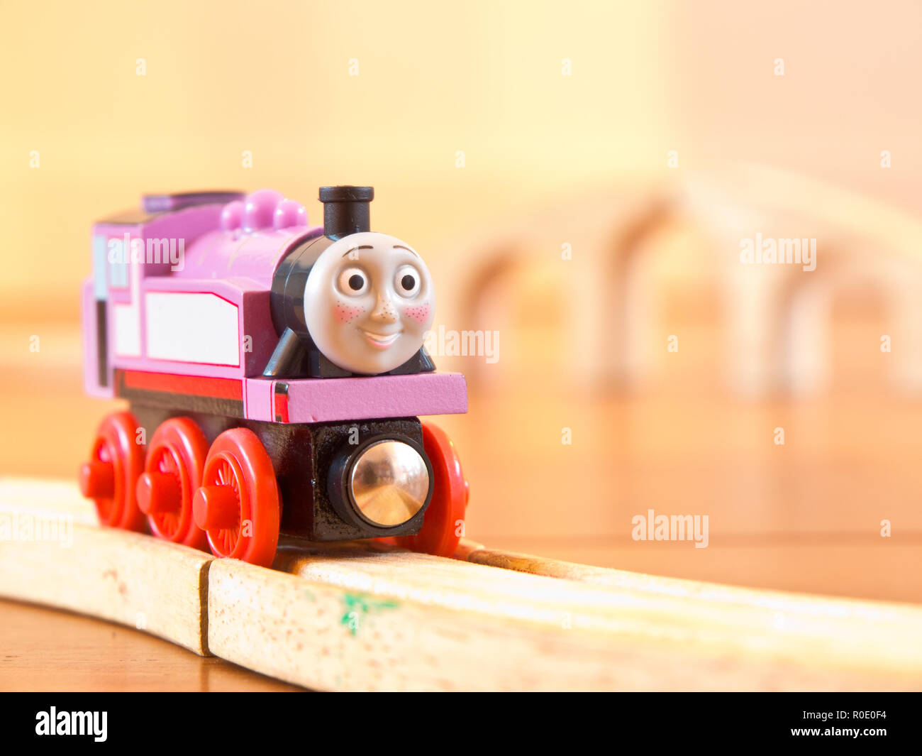 Rosie the pink Thomas the train on a wooden railroad Stock Photo