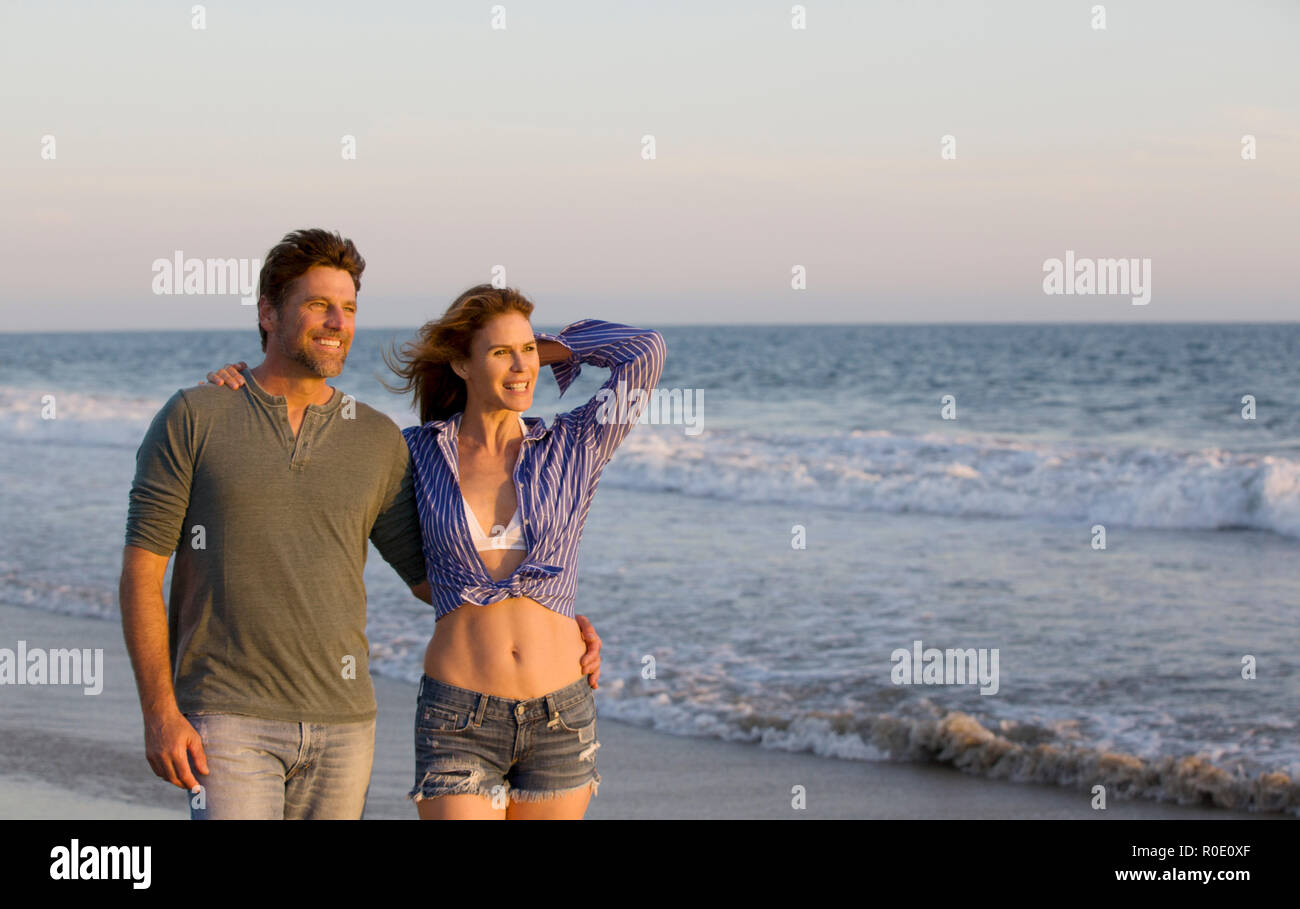 Half-Length Portrait of Smiling Mid-Adult Couple at Beach Stock Photo