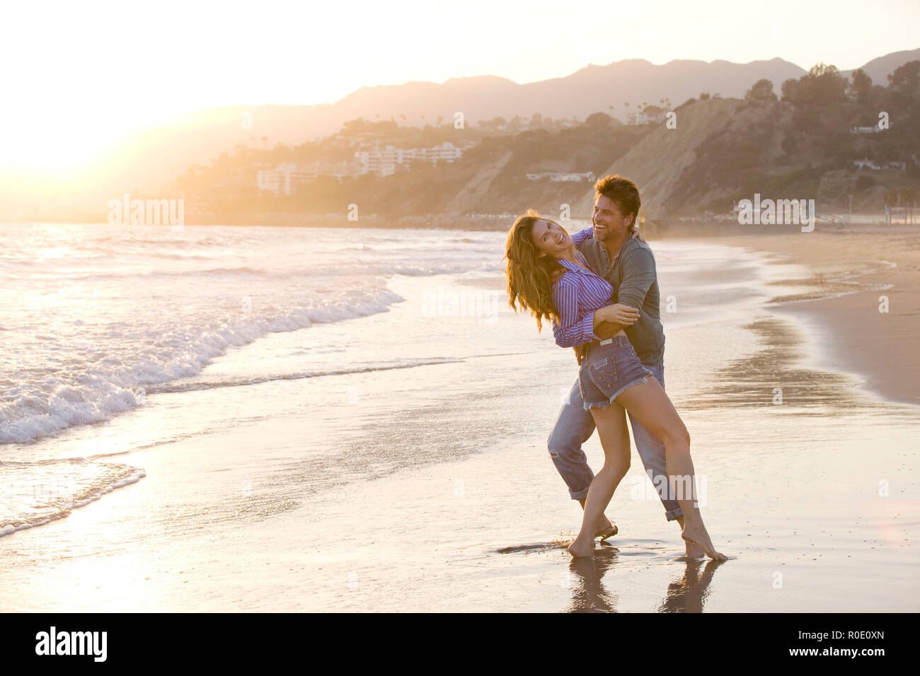 Carefree Mid-Adult Couple at Beach Stock Photo