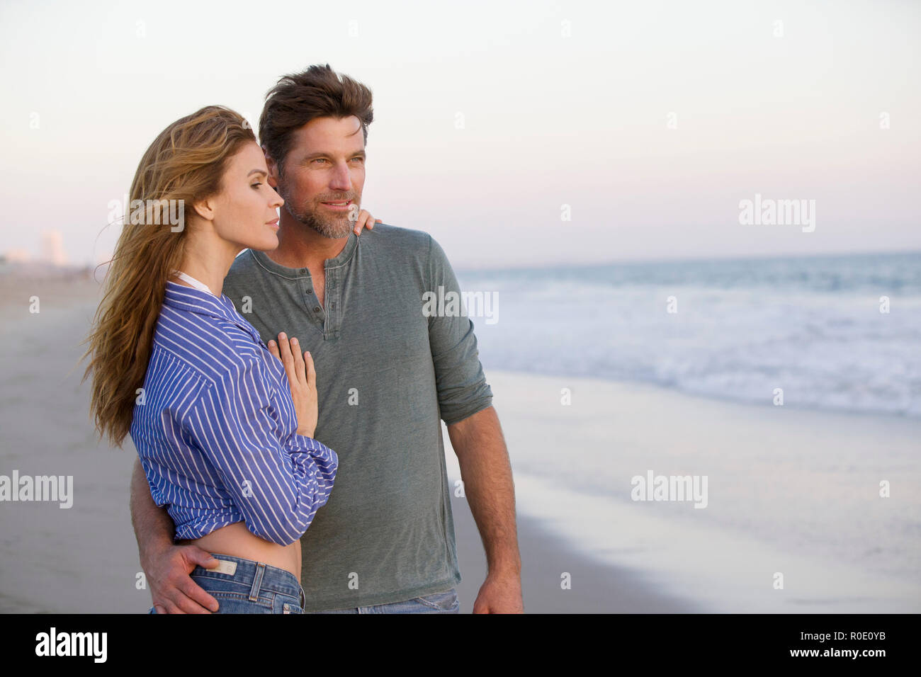 Half-Length Portrait of Mid-Adult Couple at Gazing at Ocean Stock Photo