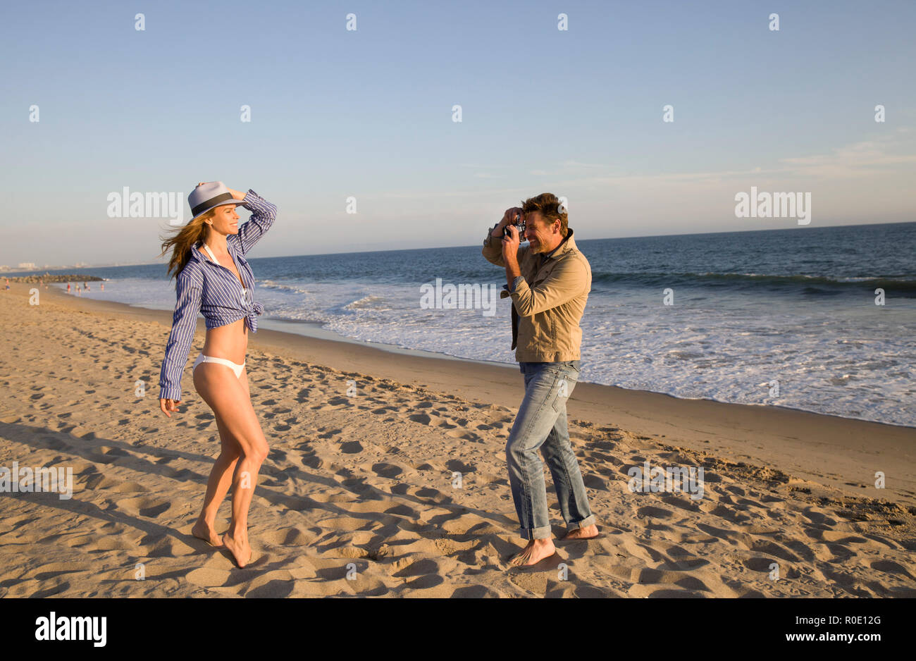 Man Taking Photo of Woman on Beach I Stock Photo