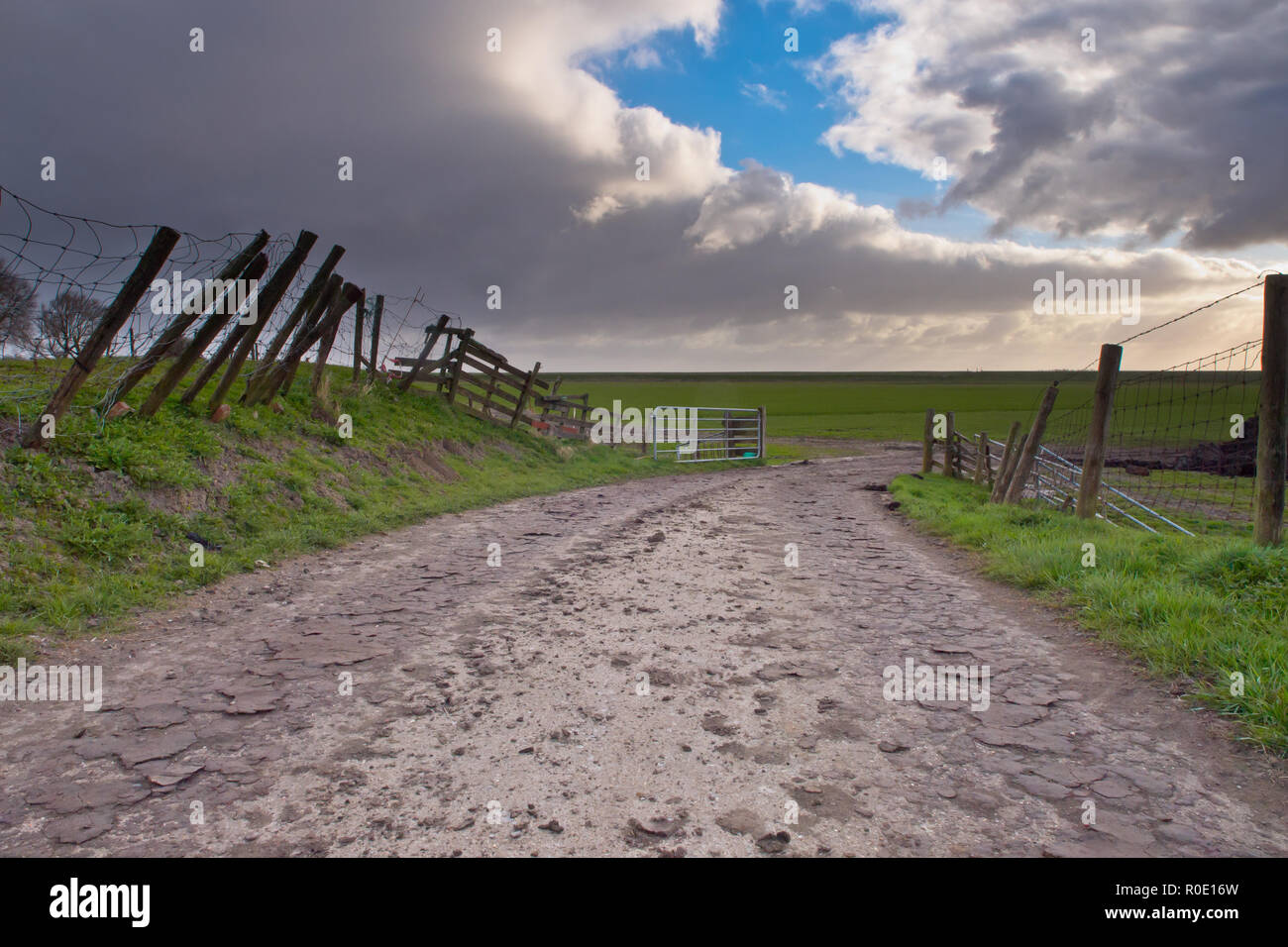 Curved country road und a curved cloudscape Stock Photo
