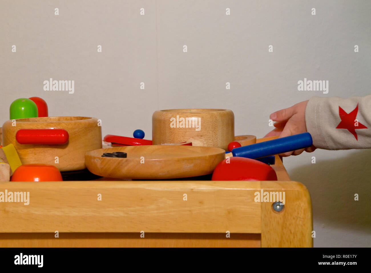 toy pots and pans on a wooden kitchen stove Stock Photo Alamy