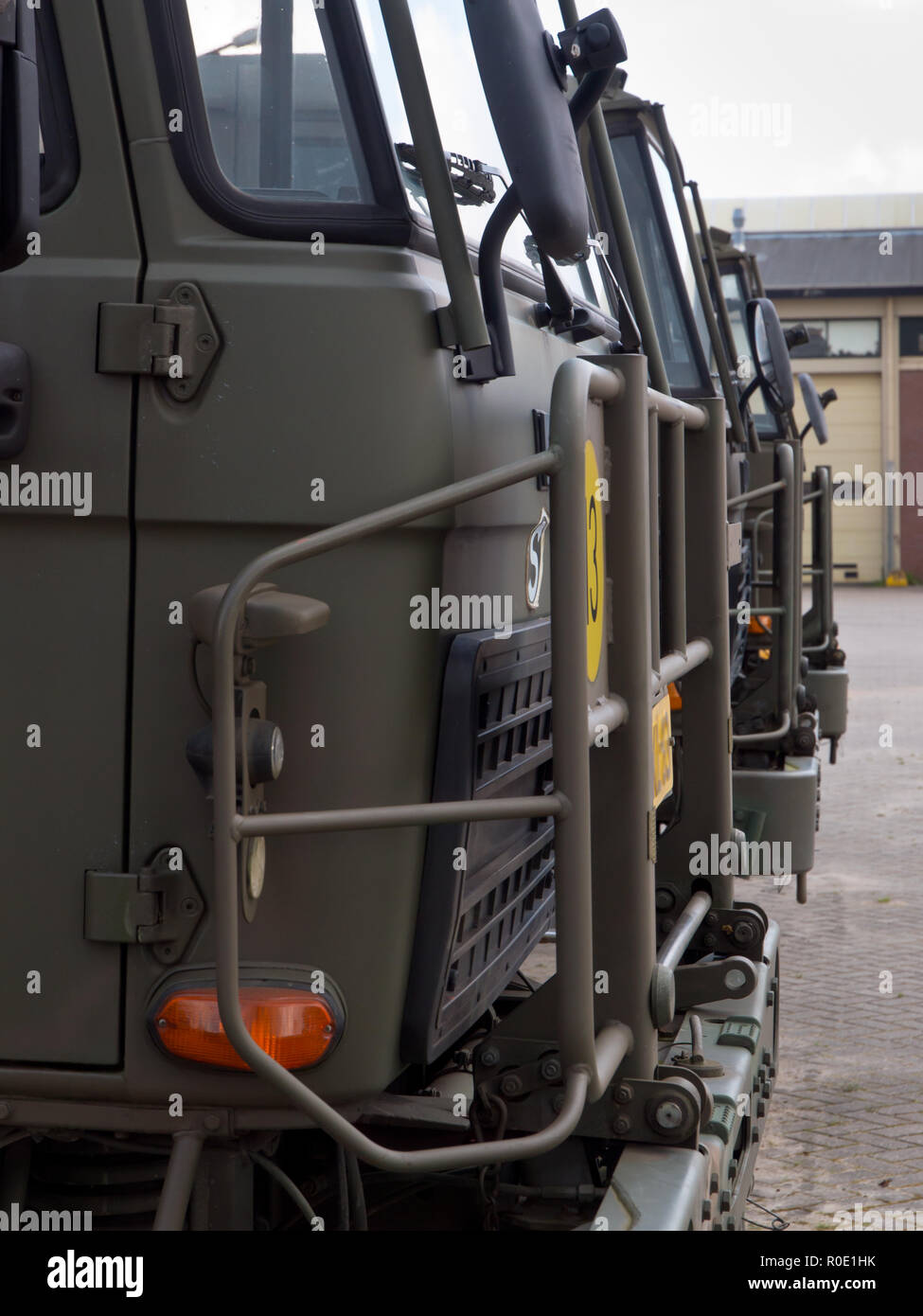 Army trucks lined up in formation Stock Photo