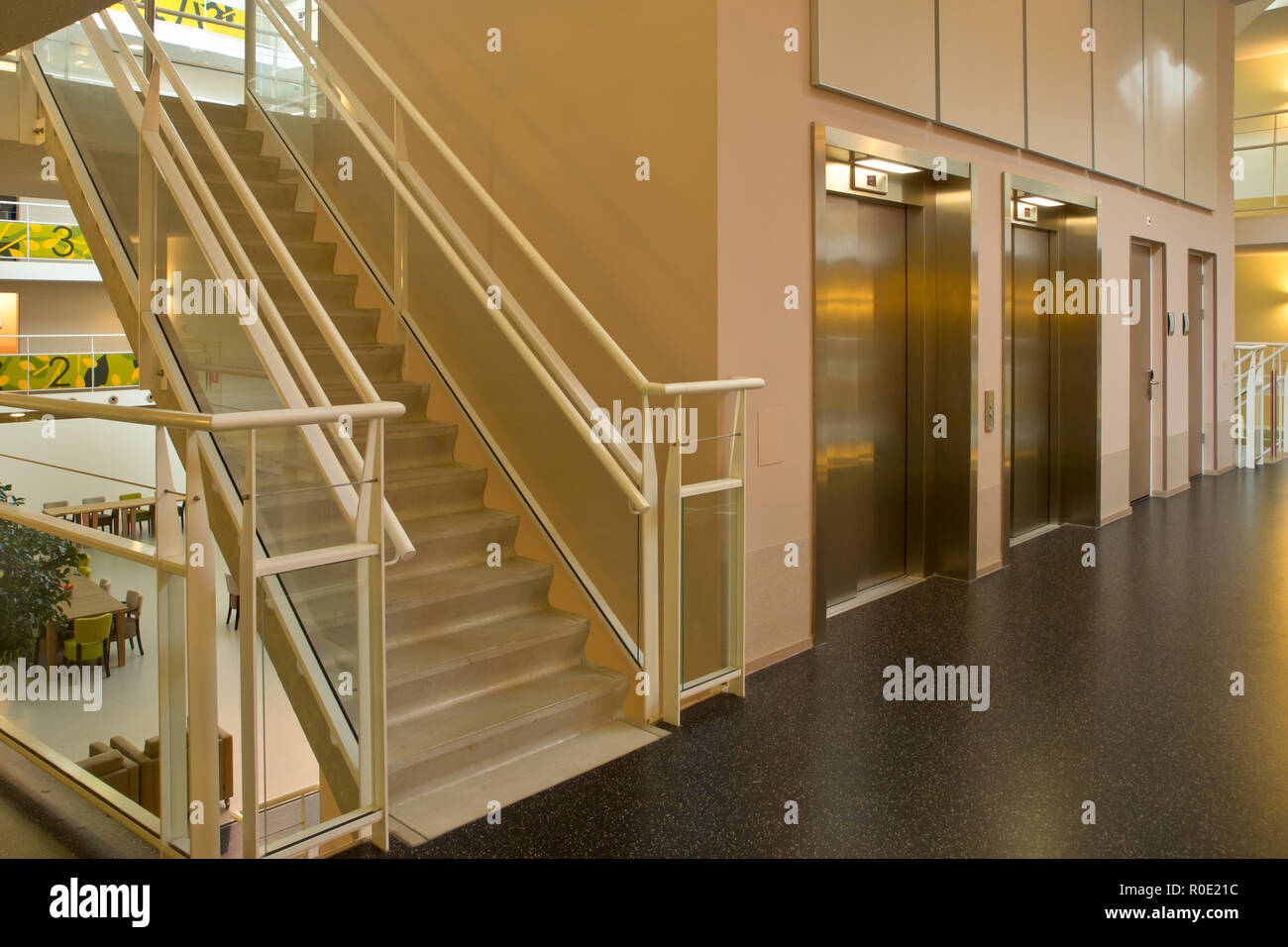 An elevator and glass staircase in a modern metropolitan building Stock ...