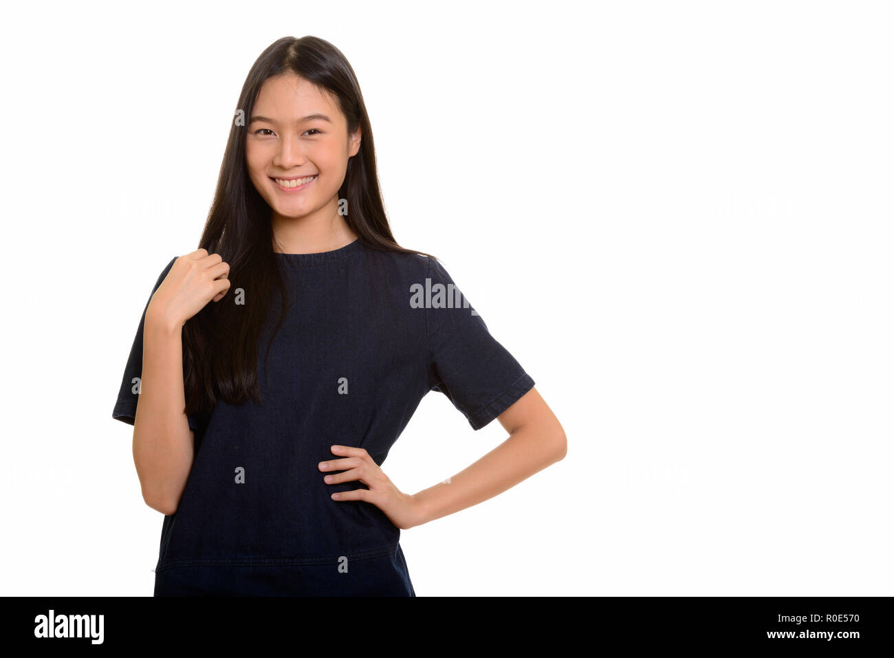 Portrait of young happy Asian teenage girl smiling Stock Photo