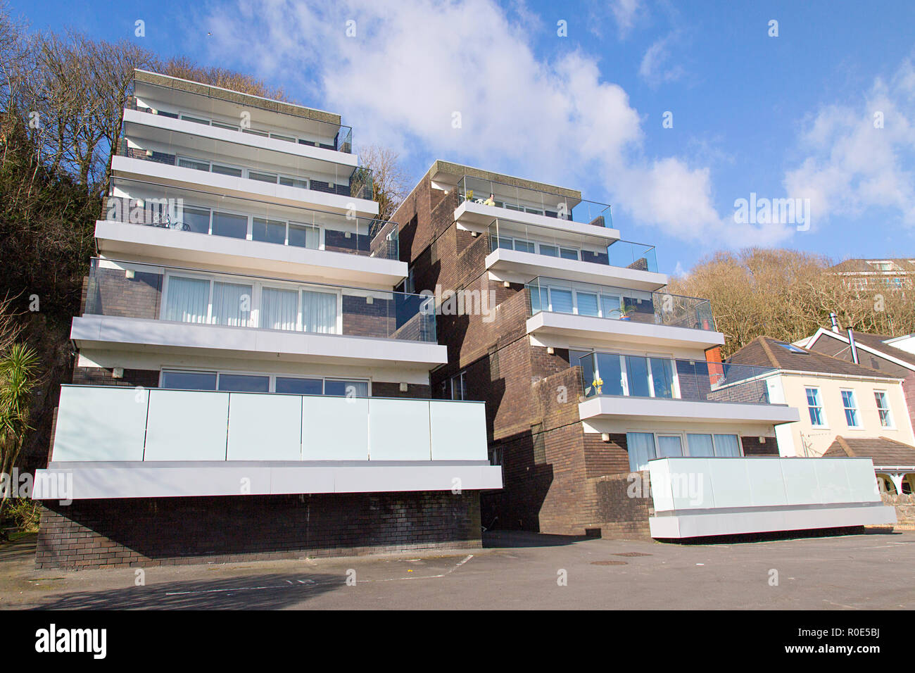 Swansea, UK: February 20, 2018: Retro 1970's designed apartment building with glass balconies to admire the view. Stock Photo