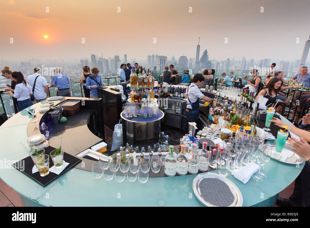 BANGKOK, THAILAND - FEBRUARY 10, 2017 : People drinking and enjoying the sunset at the Octave rooftop bar of the Marriott tower hotel in the Thong Lor Stock Photo