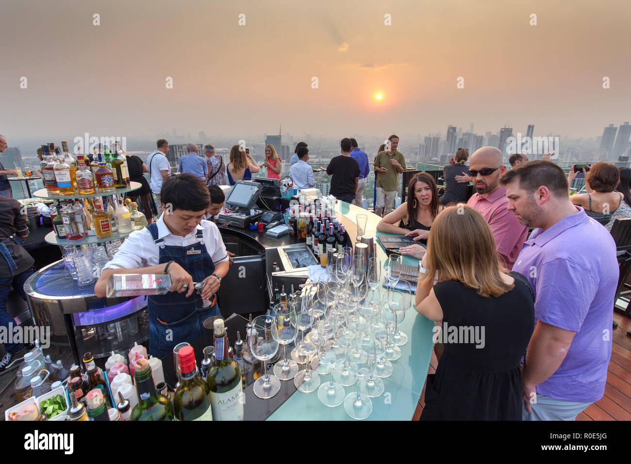 BANGKOK, THAILAND - FEBRUARY 10, 2017 : People drinking and enjoying the sunset at the Octave rooftop bar of the Marriott tower hotel in the Thong Lor Stock Photo