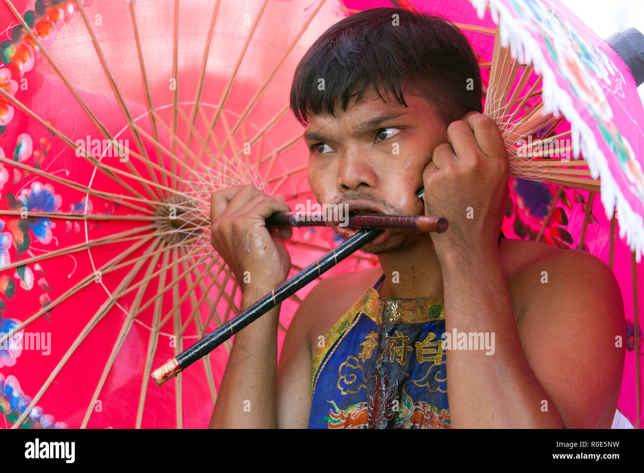 Phuket Town, THAILAND, October 07, 2016 : Devotee extreme piercing street procession during the Taoist vegetarian festival of the Nine Emperor Gods in Stock Photo