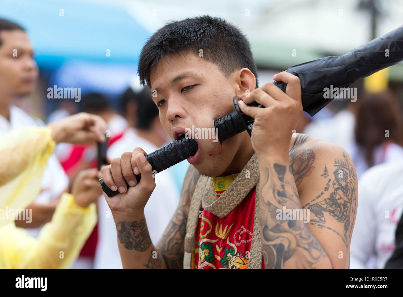 Phuket Town, THAILAND, October 06, 2016 : Devotee extreme piercing street procession during the Taoist vegetarian festival of the Nine Emperor Gods in Stock Photo