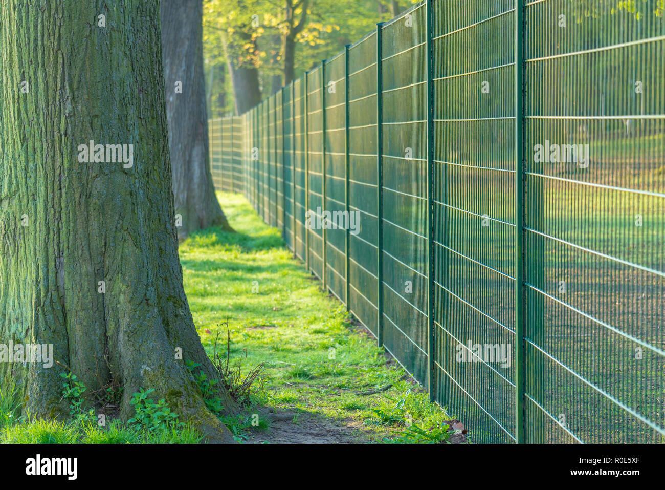 Metal fence in urban park Stock Photo - Alamy