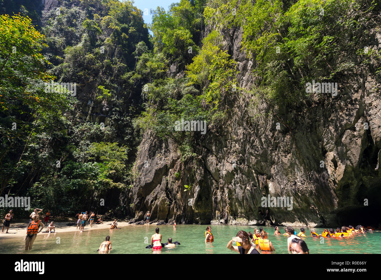 KO LANTA, THAILAND, FEBRUARY 09, 2015 : Some tourists are bathing in the natural sea pool of the Emerald cave near the Ko Lanta island in Thailand Stock Photo