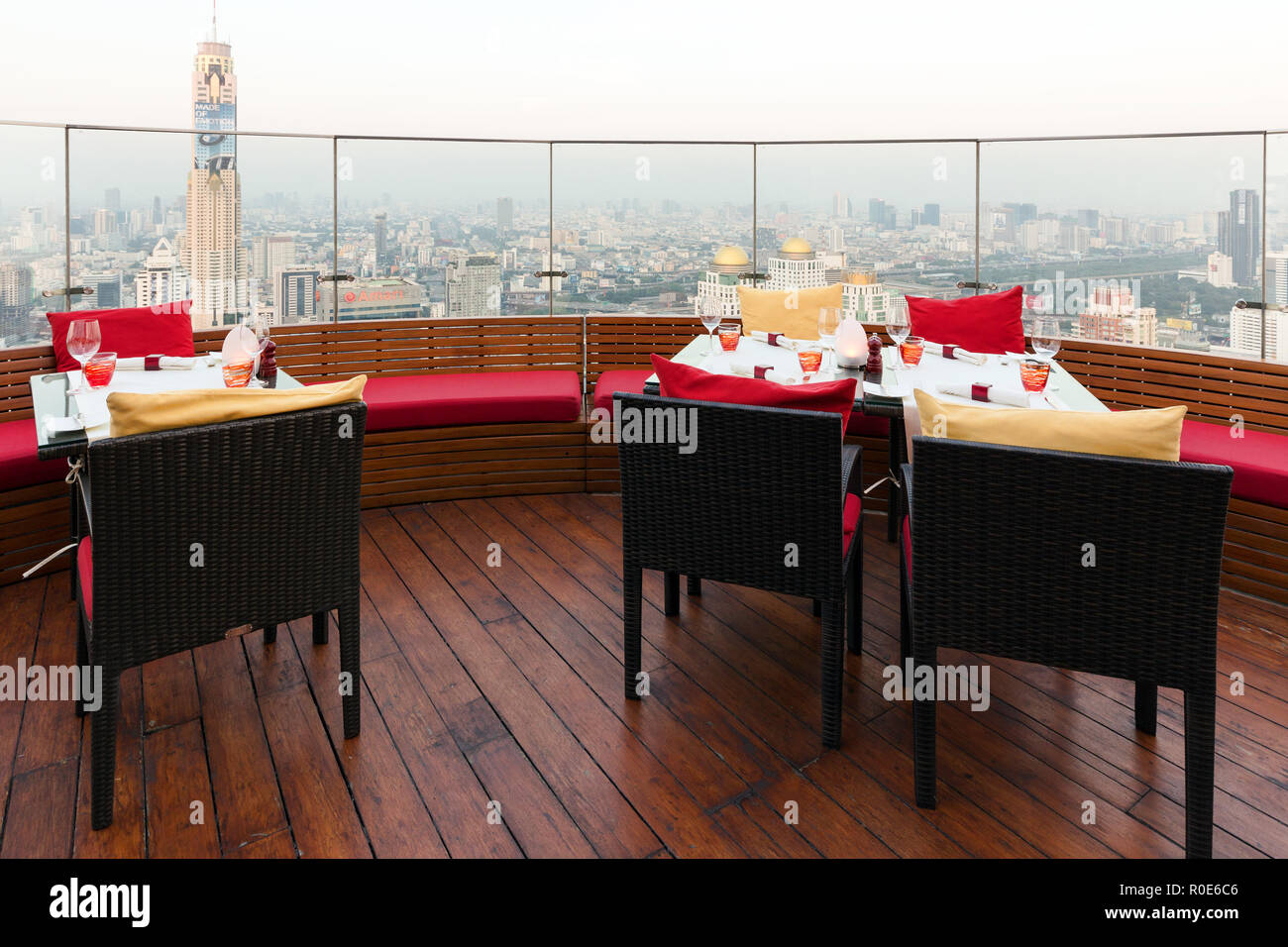 BANGKOK, THAILAND, JANUARY 14, 2015 : Restaurant table with view on the Baiyoke tower and the cityscape at the Red Sky Rooftop of the Centara hotel in Stock Photo