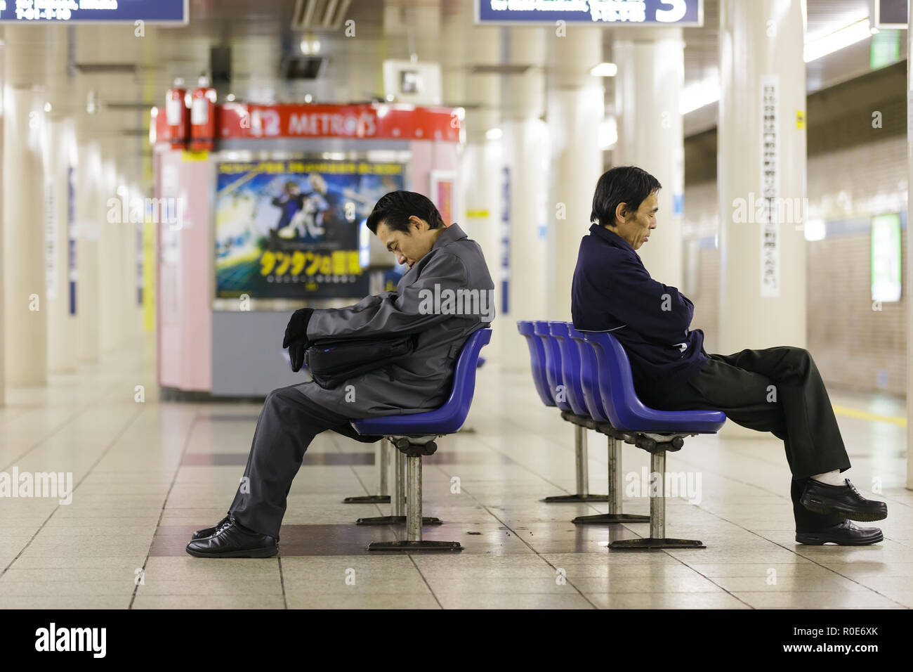 TOKYO,JAPAN, November 30 : two unidentified Japanese men sleeping in the subway waiting for the train to come, early morning in Tokyo, Japan, on Novem Stock Photo