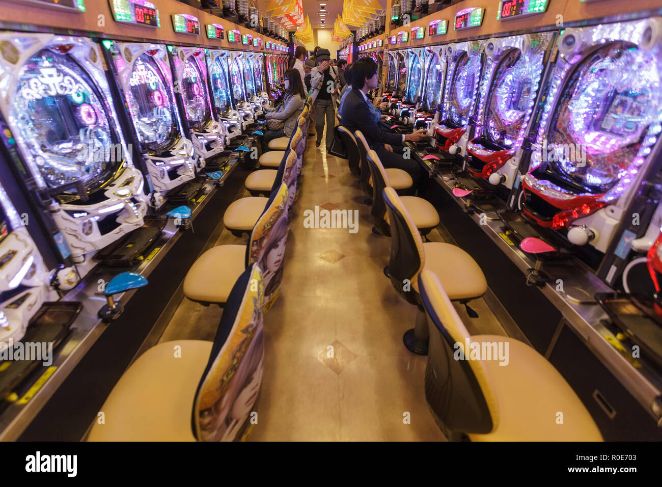 KYOTO, JAPAN, NOVEMBER 15, 2011: Some customers are gambling in a Pachinko hall, traditional Japanese Game in Kyoto, Japan Stock Photo