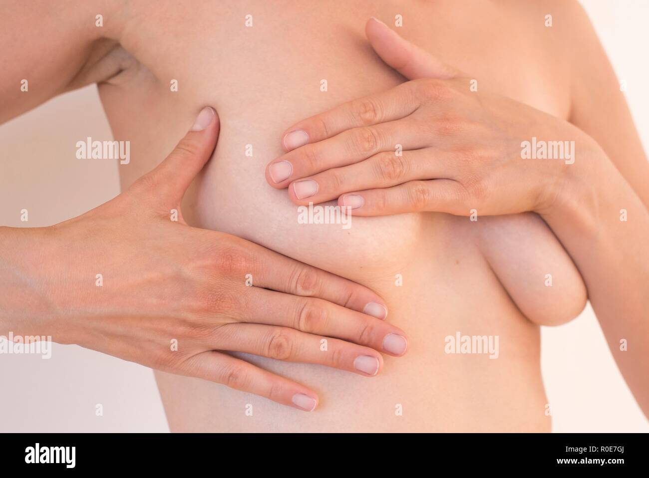 Young woman examining her breast. Stock Photo