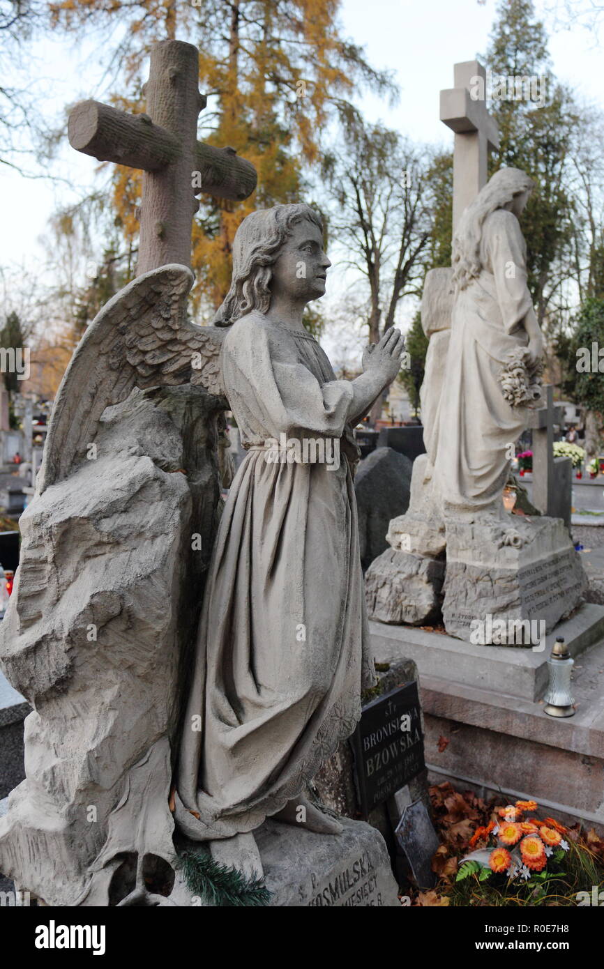 All Saints' Day. Tombstone sculptures of angels in cemetery in Poland Stock Photo