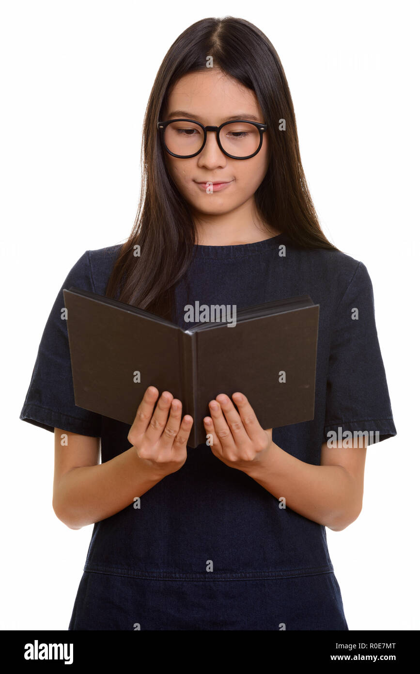 Young beautiful Asian teenage girl reading book  Stock Photo