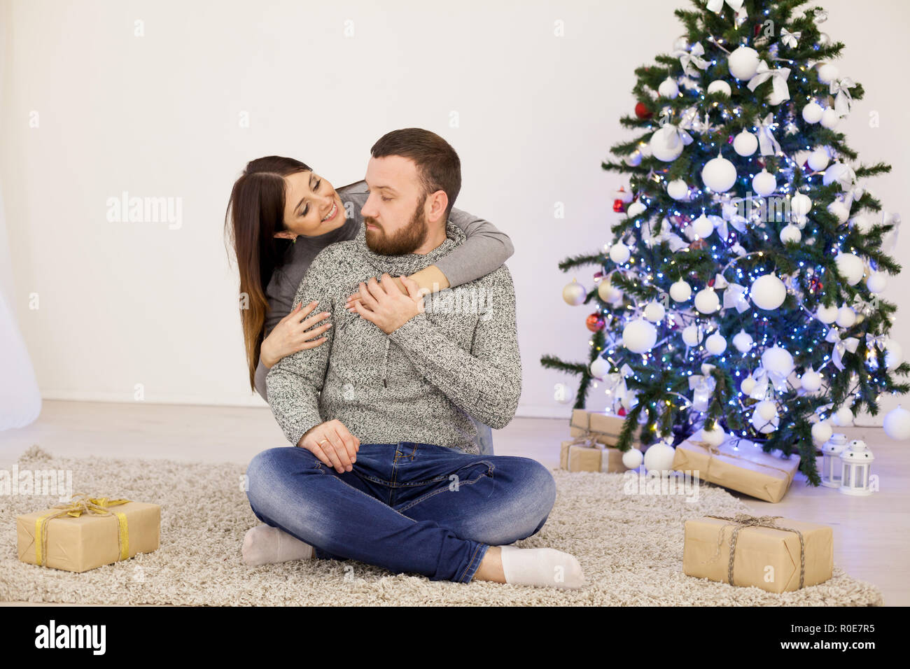 husband and wife Christmas Christmas tree with gifts Stock Photo Alamy