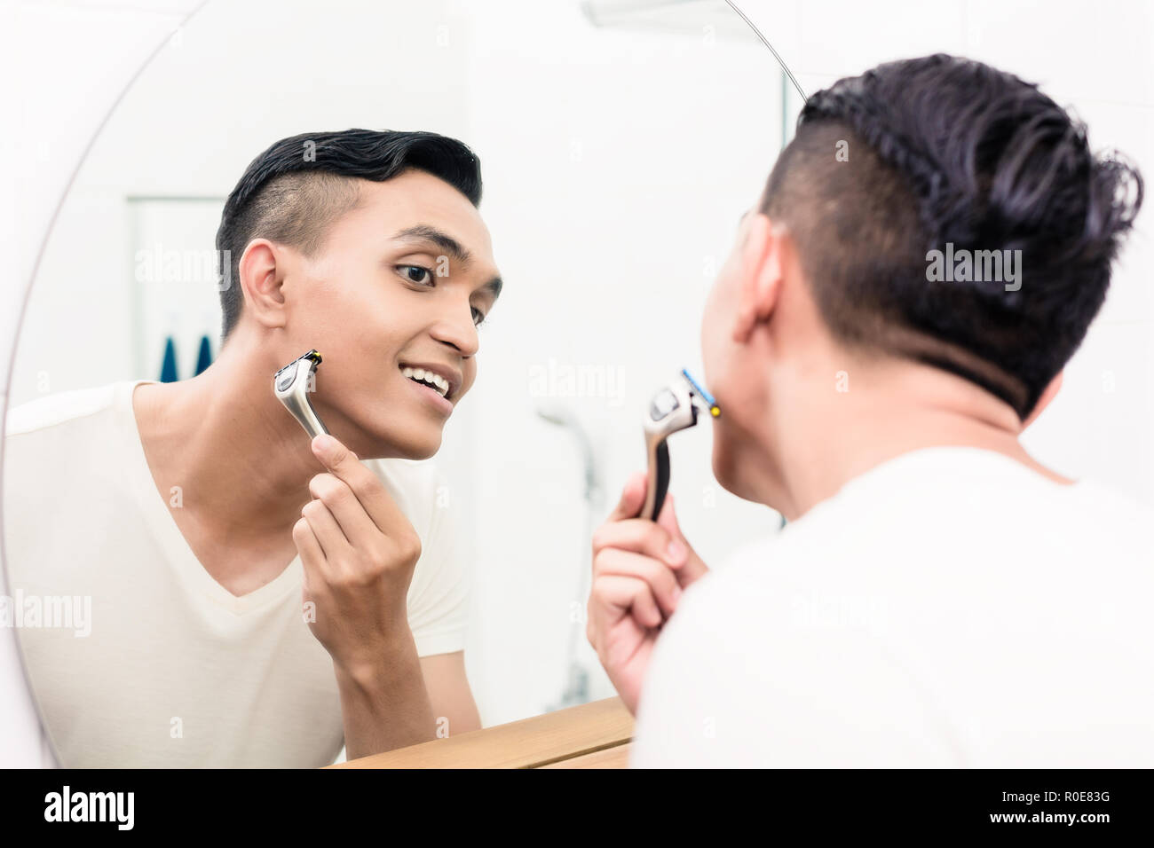 Man shaving with razor Stock Photo